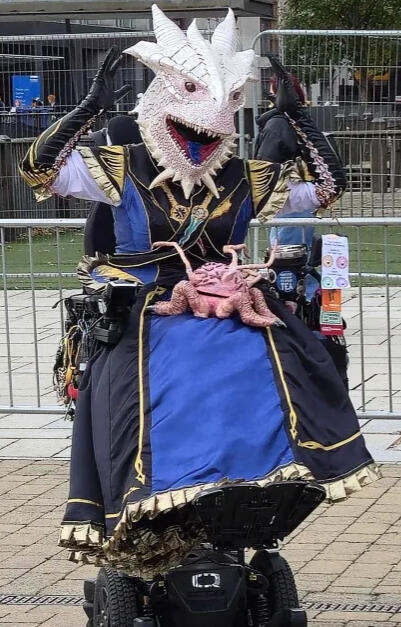 The Dark Urge Bhaalgown - A reimagining of the default Dark Urge dragonborn in a ballgown version of the starting outfit, complete with embroidered daggers on the crossbelt and a headpiece with glowing red eyes. And the intellect devourer, "Us"!